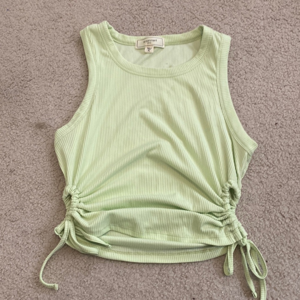 Green crop tank top with cinched side cutouts